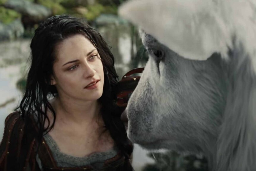 Snow White (Kristen Stewart) has an intimate moment with a magical creature in Snow White and the Huntsman (2012).