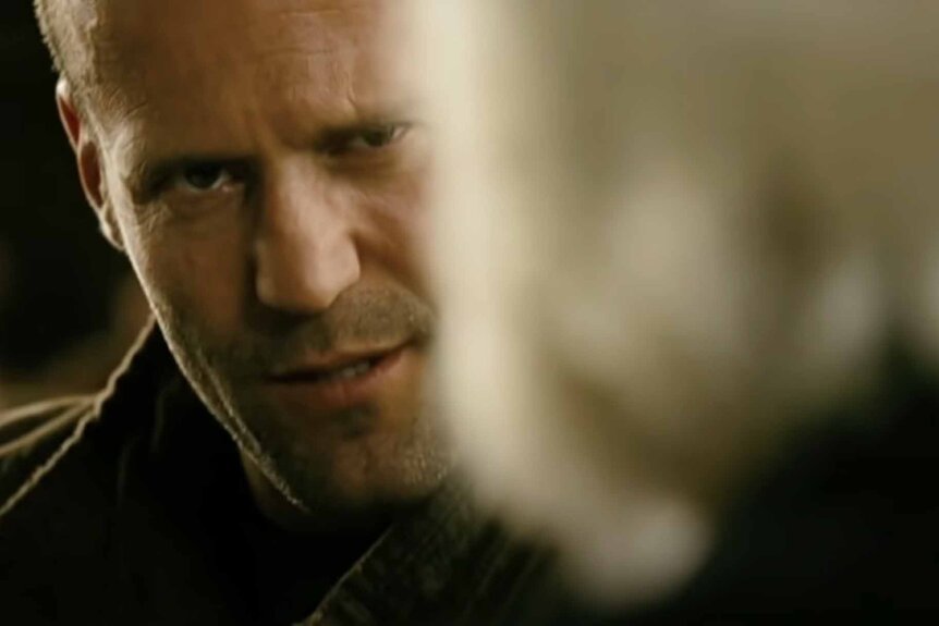 Arthur Bishop (Jason Statham) talks to a white haired man in The Mechanic (2011).