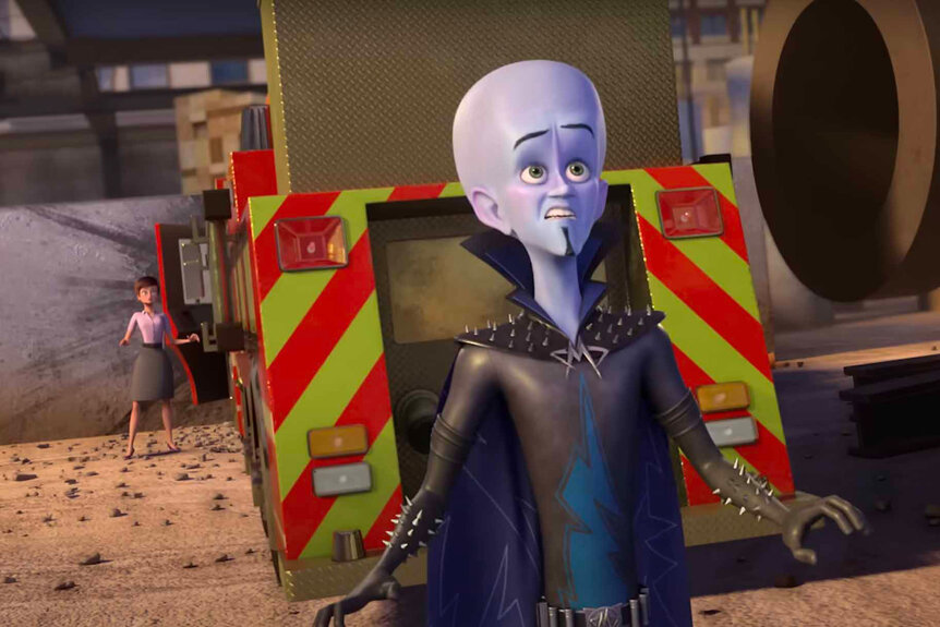 Megamind stands in front of an emergency vehicle in Megamind vs. The Doom Syndicate (2024).
