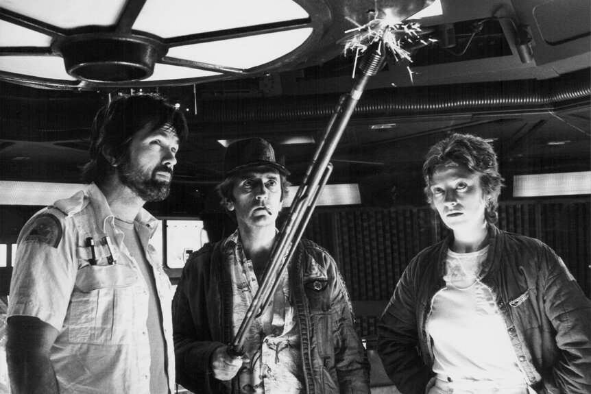 Dallas (Tom Skerritt), Brett (Harry Dean Stanton), and Lambert (Veronica Cartwright) use an electric stick in Alien (1979)