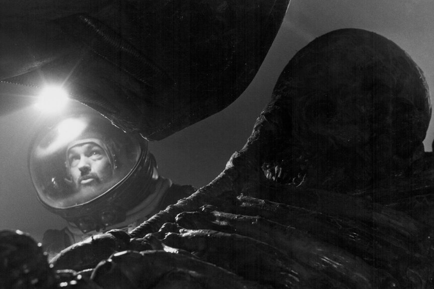 Dallas (Tom Skerritt) wears a spacesuit with a light in Alien (1979)