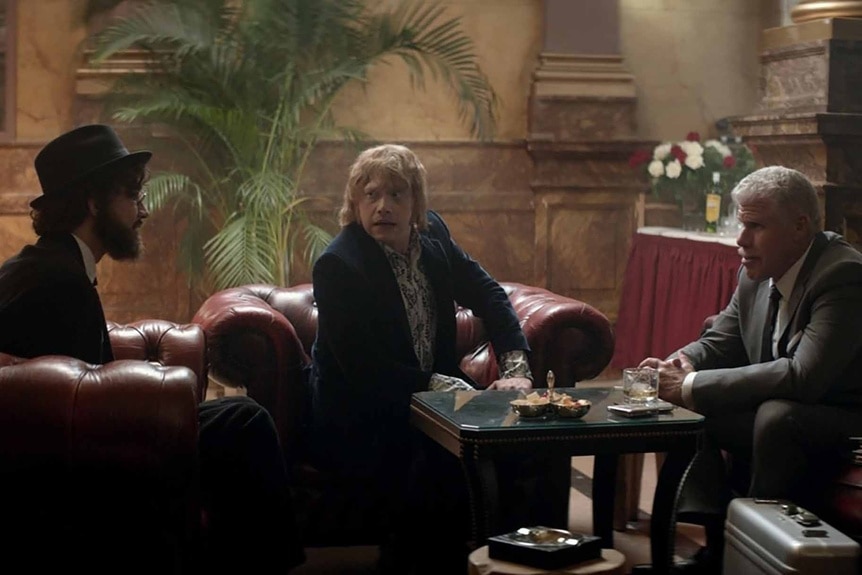 Leon (Robert Sheehan), Jonny (Rupert Grint), and Kidman (Ron Perlman) sit and talk in Moonwalkers (2016).