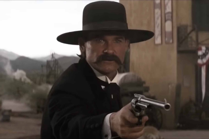Wyatt Earp (Kurt Russell) points a gun in Tombstone (1993).