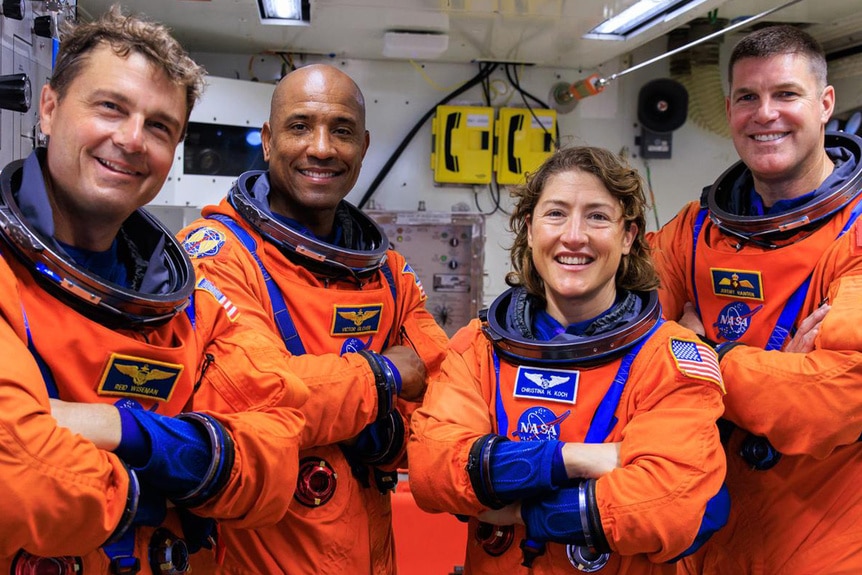 All four Artemis II astronauts posing together in their flight suits. Ried Wiseman, Christina Koch, Victor Glover and Jeremy Hansen.