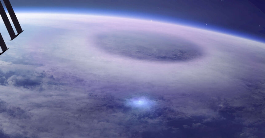 Artwork depicting an ELVES (the circle of light) expanding into the ionosphere, created by a blue flash and jet at the cloud top of a thunderstorm. Credit: DTU Space, Mount Visual / Daniel Schmelling
