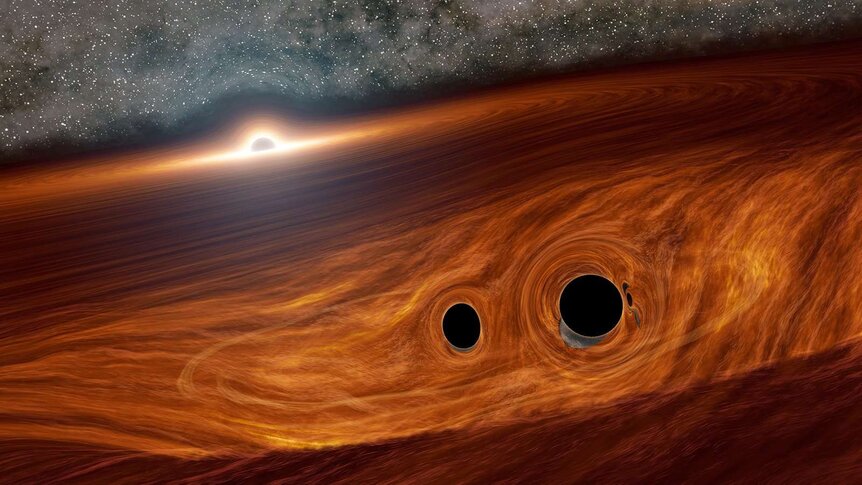 A binary pair of black holes about to merge together, near the huge disk of material swirling around a supermassive black hole in a distant active galaxy. Credit: Caltech/R. Hurt (IPAC)
