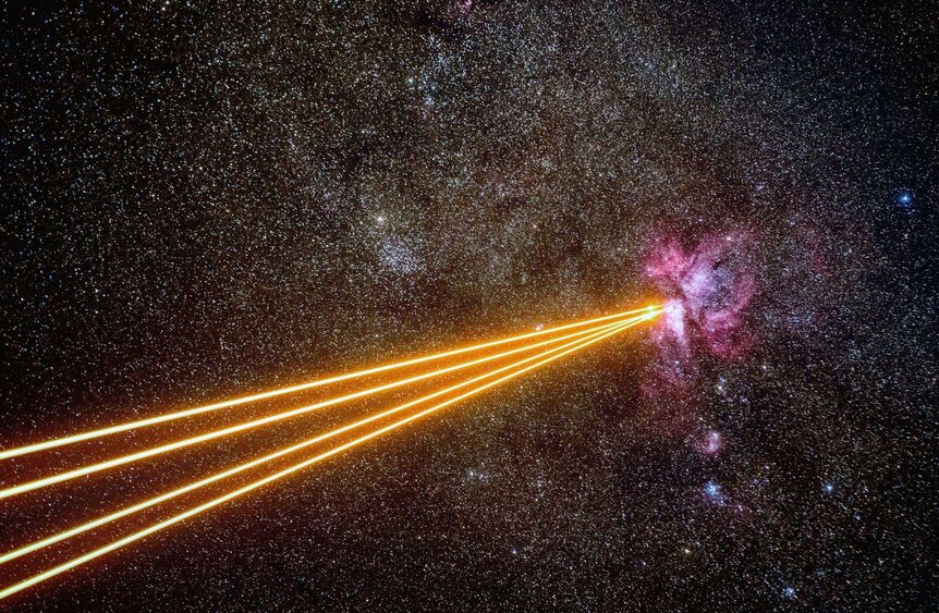 Four powerful lasers fire from the Very Large Telescope to create artificial guide stars in the sky near the Carina Nebula. Credit: ESO/G. Hüdepohl