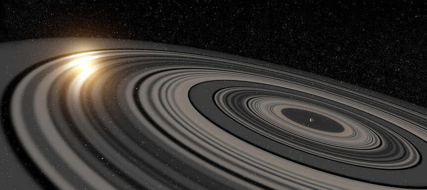Art depicting a newly formed exoplanet, still surrounded by the disk of gas and dust from which it formed, sculpted into a vast set of Saturn-like rings. Credit: Ron Miller