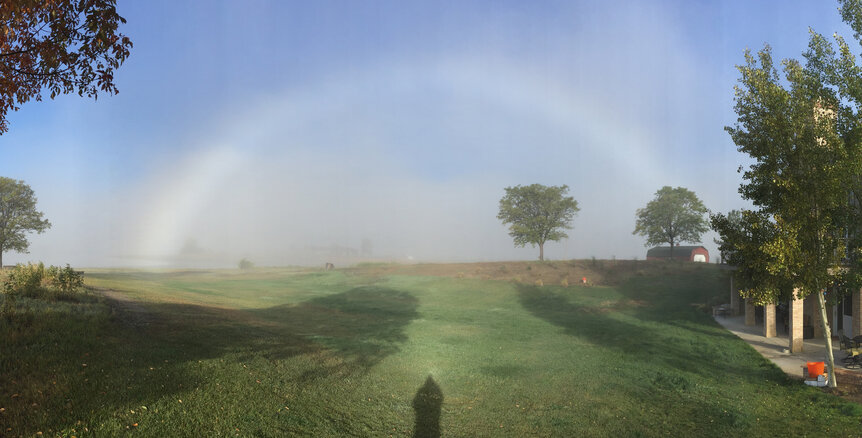 A fogbow created by the tiny droplets of water in a fog with strong sunlight behind the observer. Credit: Phil Plait