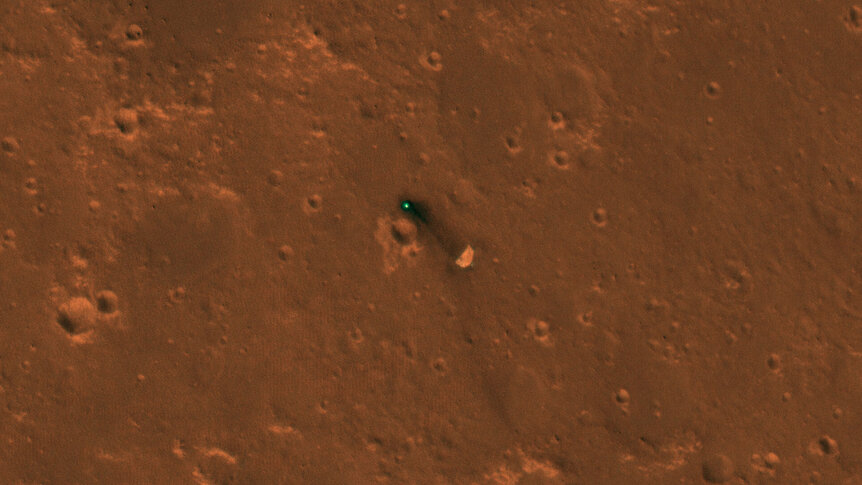 The Mars InSight parachute (lower right) and backshell on the surface of Mars. Credit:  NASA/JPL/University of Arizona 