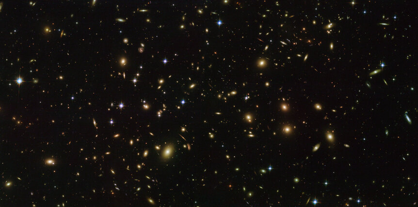 The immense galaxy cluster Abell 2163 is 2.5 billion light years away and contains hundreds of massive galaxies. Credit: ESA/Hubble &amp; NASA