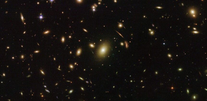 The central galaxies of Abell 2163, including a giant elliptical galaxy that sits at the cluster’s heart. Credit: ESA/Hubble & NASA