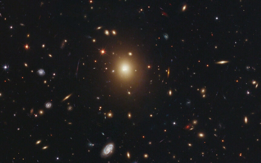 A Hubble Space Telescope image of the center of the galaxy cluster Abell 2261, showing the enormous central galaxy. Nearly everything you see in this image is a galaxy.