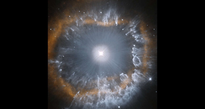 Hubble observations from 1994 show the inner part of the nebula around AG Carinae. Note that where the dust is thicker (blue), the hydrogen gas ring (red) is less circular; that may indicate the ring has trouble expanding into thicker material.