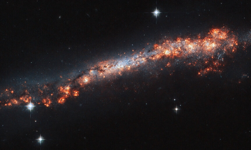 The edge-on spiral galaxy NGC 3432 shows off a lot of gas clouds in this image from Hubble Space Telescope. Credit: ESA/Hubble & NASA, A. Filippenko, R. Jansen