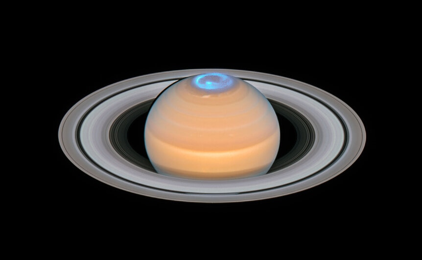 An aurora glows in ultraviolet light in this composite image of Saturn taken by Hubble in 2017 and 2018. Credit: ESA/Hubble, NASA, A. Simon (GSFC) and the OPAL Team, J. DePasquale (STScI), L. Lamy (Observatoire de Paris)