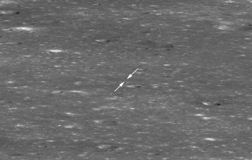 The Chinese lander Chang’e-4 and rover Yutu-2 are both in this image (arrowed) taken by the Lunar Reconnaissance Orbiter, but from so far away they are only a couple of pixels across. NASA/GSFC/Arizona State University
