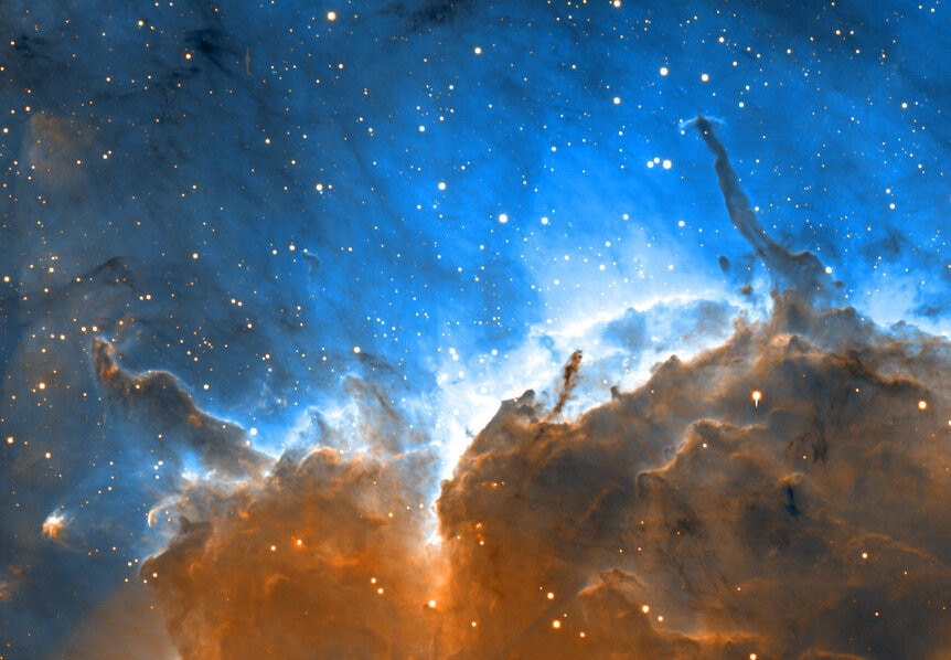 Stars inside the Pelican Nebula illuminate and erode away the edge of a dense molecular cloud, creating what’s called an ionization front, where stars are being born. Credit: University of Colorado, University of Hawaii and NOAO/AURA/NSF