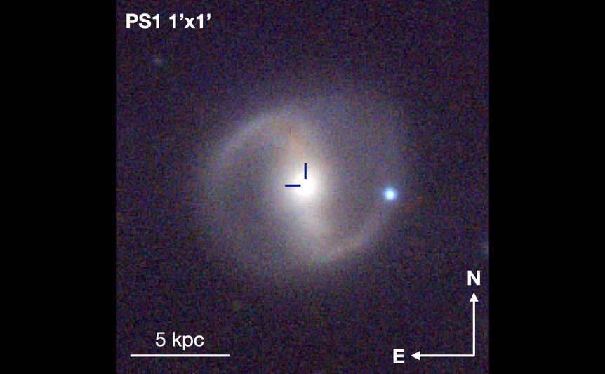 An image of the host galaxy for the tidal disruption event AT2019qiz, imaged by the Pan-STARRS telescope. The position of the TDE is in the crosshairs, right in the center of the galaxy. The scale bar is about 17,000 light years.