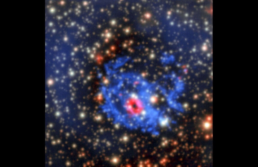A ring of red light from dense gas surrounds the first neutron star ever detected in another galaxy (which is too faint in visible light to see here). Credit: ESO/F. Vogt et al.