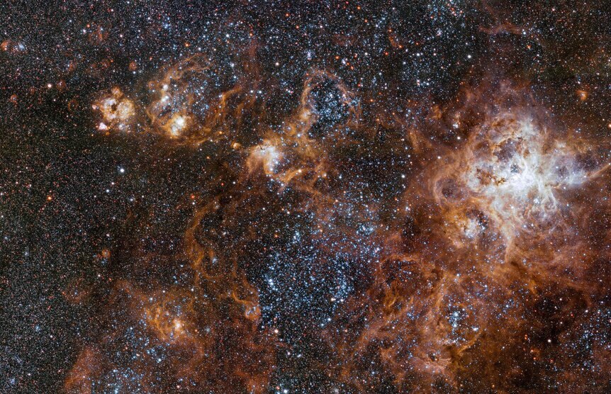 The hugely sprawling Tarantula Nebula, a vast star-forming complex in a nearby satellite galaxy of the Milky Way. It's currently making hundreds of thousands of stars. Credit: ESO