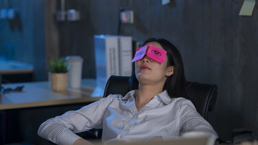 Young woman asleep in office.