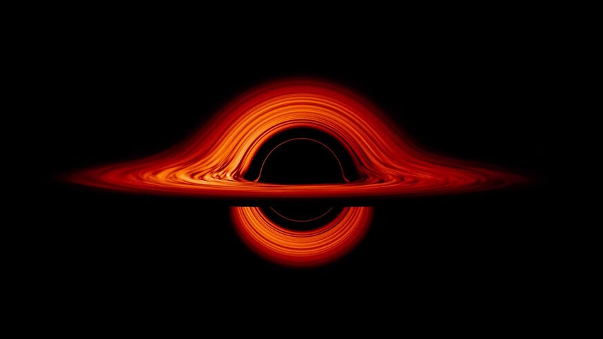 A simulation of what a black hole with a disk of gas swirling around it would look, given the bizarre effects of its fierce gravity on the light from the disk. Credit: NASA’s Goddard Space Flight Center/Jeremy Schnittman