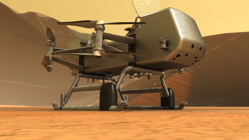 Artwork of the dual-quadcopter Dragonfly sitting on the surface of Saturn’s huge moon Titan. Credit: JHUAPL / Michael Carroll