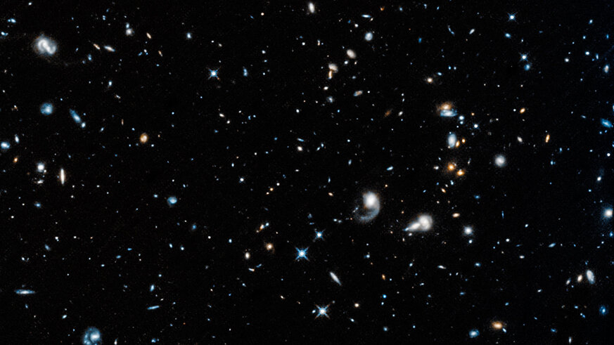 Distant galaxies pepper this deep infrared image of the sky, the first taken by Hubble after being reactivated after several weeks of being in safe mode due to a busted gyro. This image has been enlarged and slightly contrast-enhanced from original.