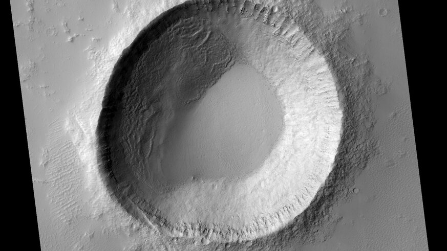 A spectacular if oddly shaped crater near the equator on Mars, situated between two ancient volcanoes. Credit: NASA/JPL/University of Arizona