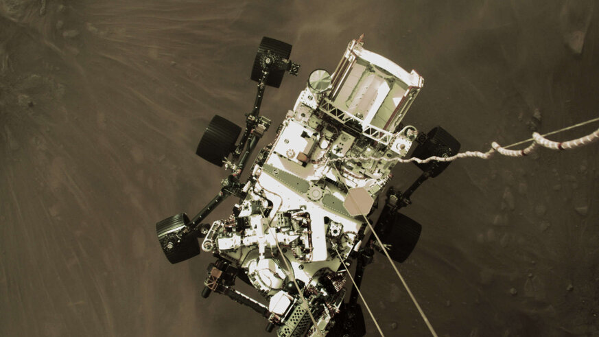 This phenomenal shot looking down from the sky crane shows the rover hanging by cables under the crane when it was about 2 meters from the surface of Mars. Credit: NASA/JPL-Caltech
