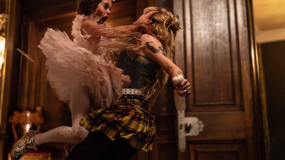 Abigail (Alisha Weir) wears a tutu and attacks Sammy (Kathryn Newton) in Abigail (2024).