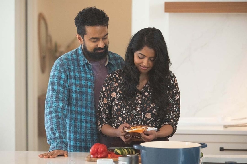 (l-r) Zayan (Varun Saranga) and Joiti (Sugenja Sri) prepare food together on SurrealEstate 209.