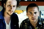 O (Aaron Taylor-Johnson) and Chon (Taylor Kitsch) appear in Savages (2012).